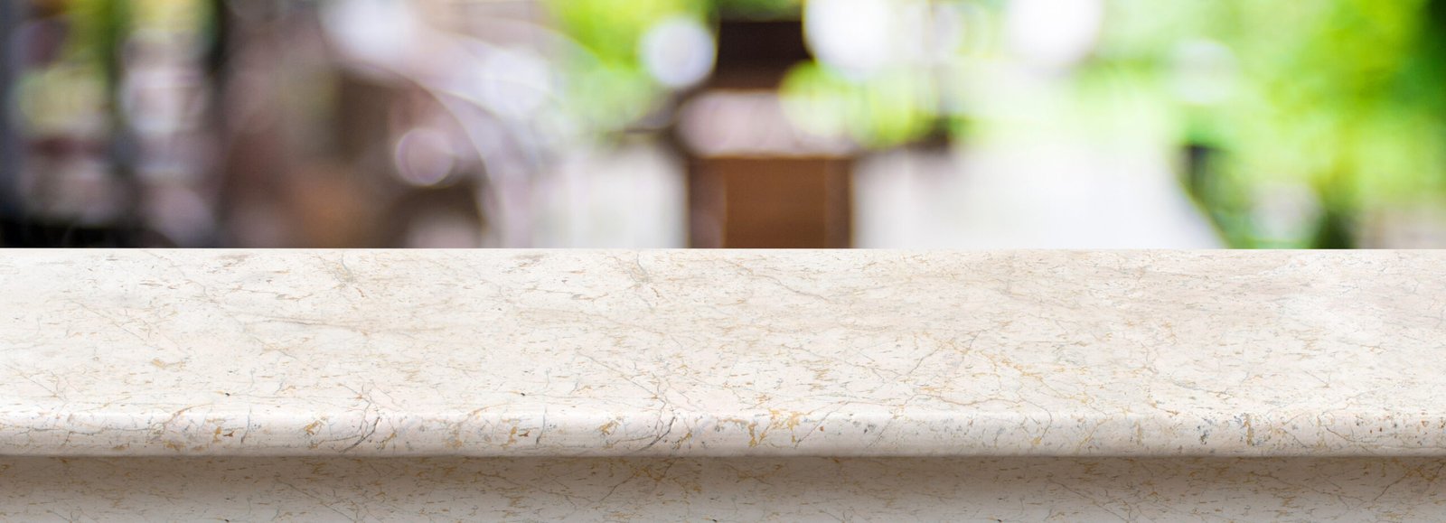 Empty luxury white marble table top with blurred cafe bokeh